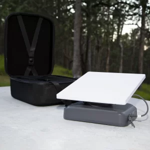 StarGrid 288Wh Starlink Mini battery on a table in tghe outdoors with black protective case open behind it